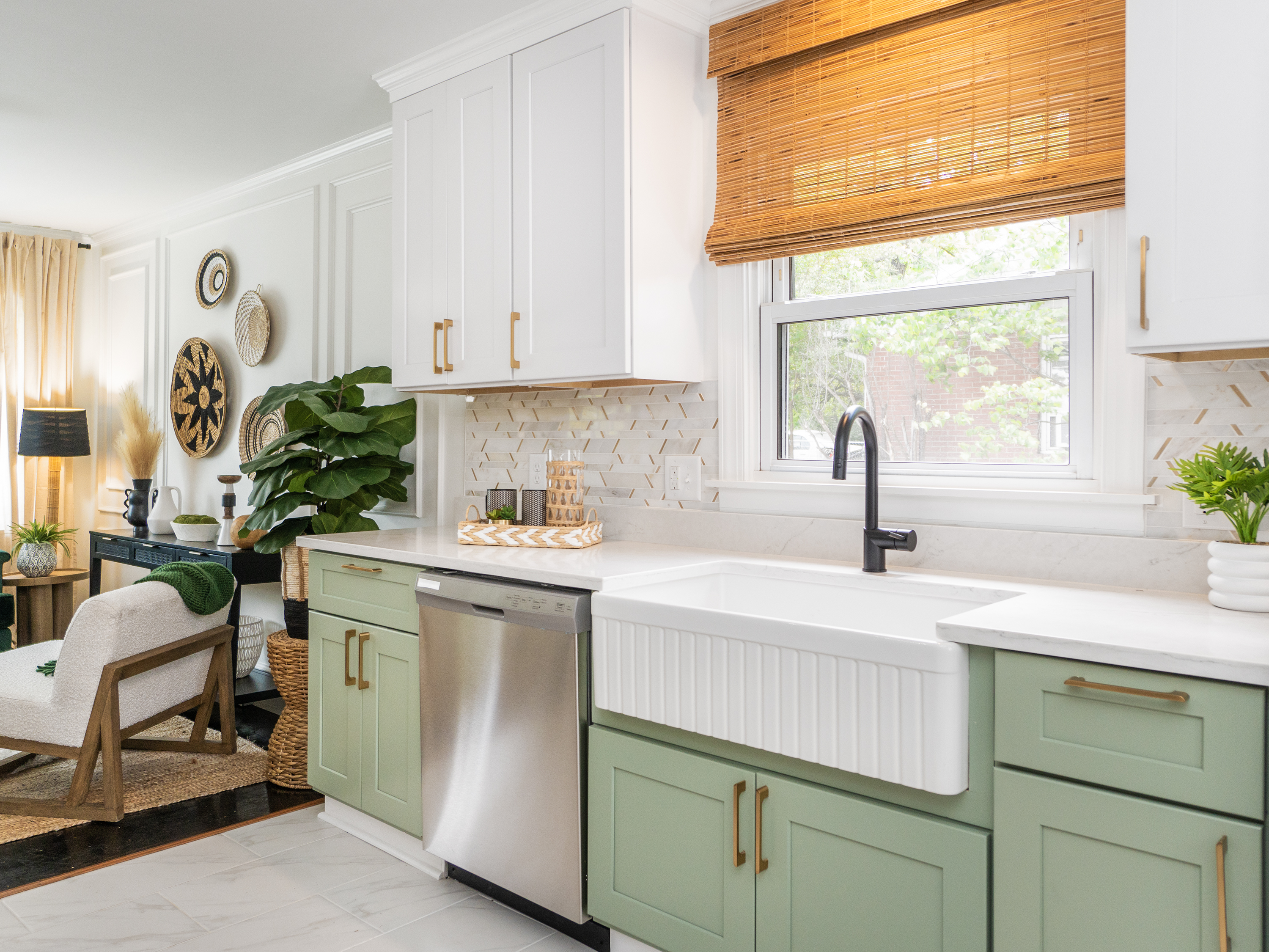 White upper kitchen cabinets and greenlower kitchen cabinets with a white farmhouse sink